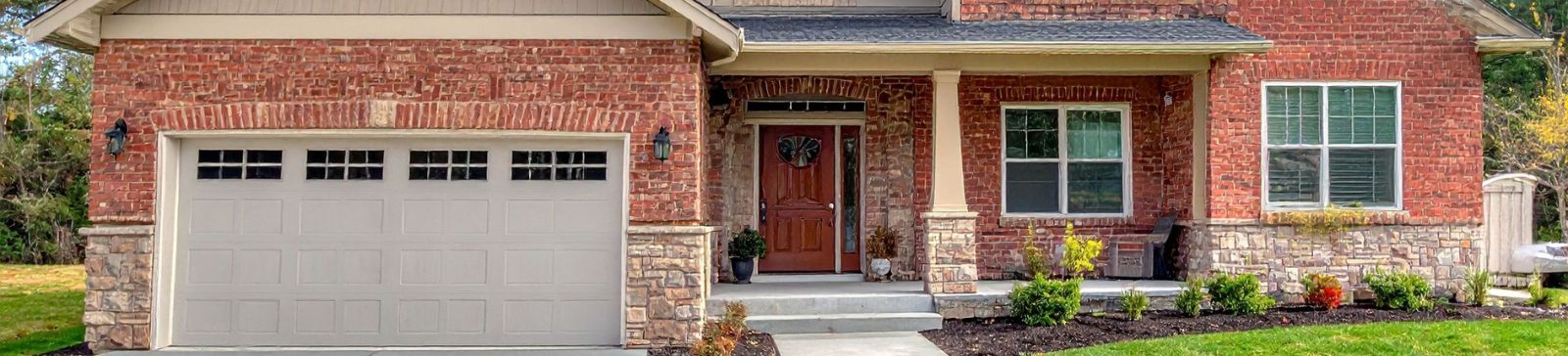 Brick home in Belleville NJ with modern garage door, representing easy access to professional garage door assistance