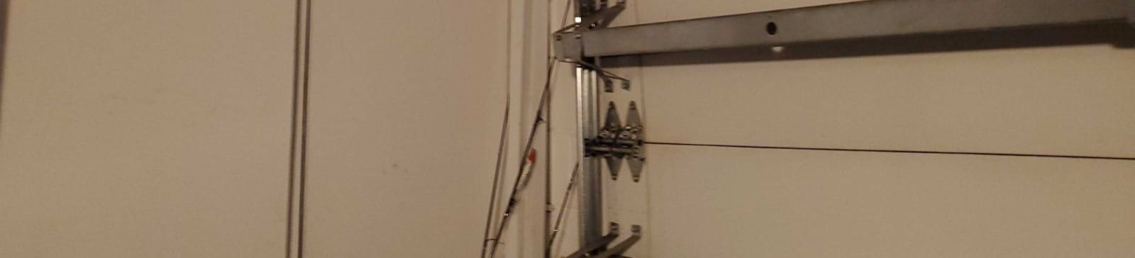 Garage door cable repair service in Kearny NJ showing cable replacement and maintenance work