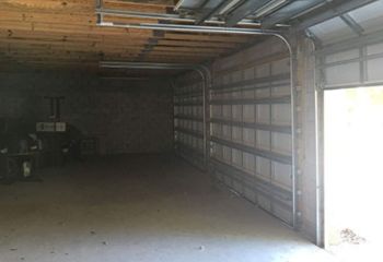 Garage door repair service in Bloomfield NJ showing door reinstallation and track adjustment