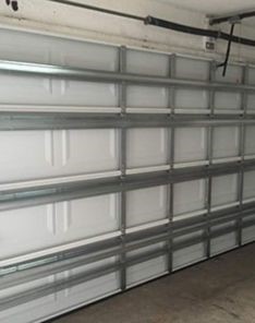 Garage door repair service in Bloomfield NJ showing door reinstallation and track adjustment