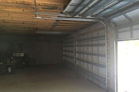 Garage door repair service in Bloomfield NJ showing door reinstallation and track adjustment