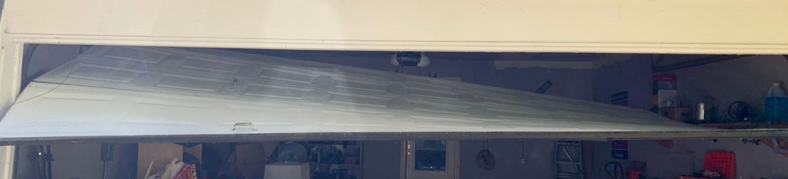 Close-up of bent garage door track requiring urgent repair in Nutley NJ